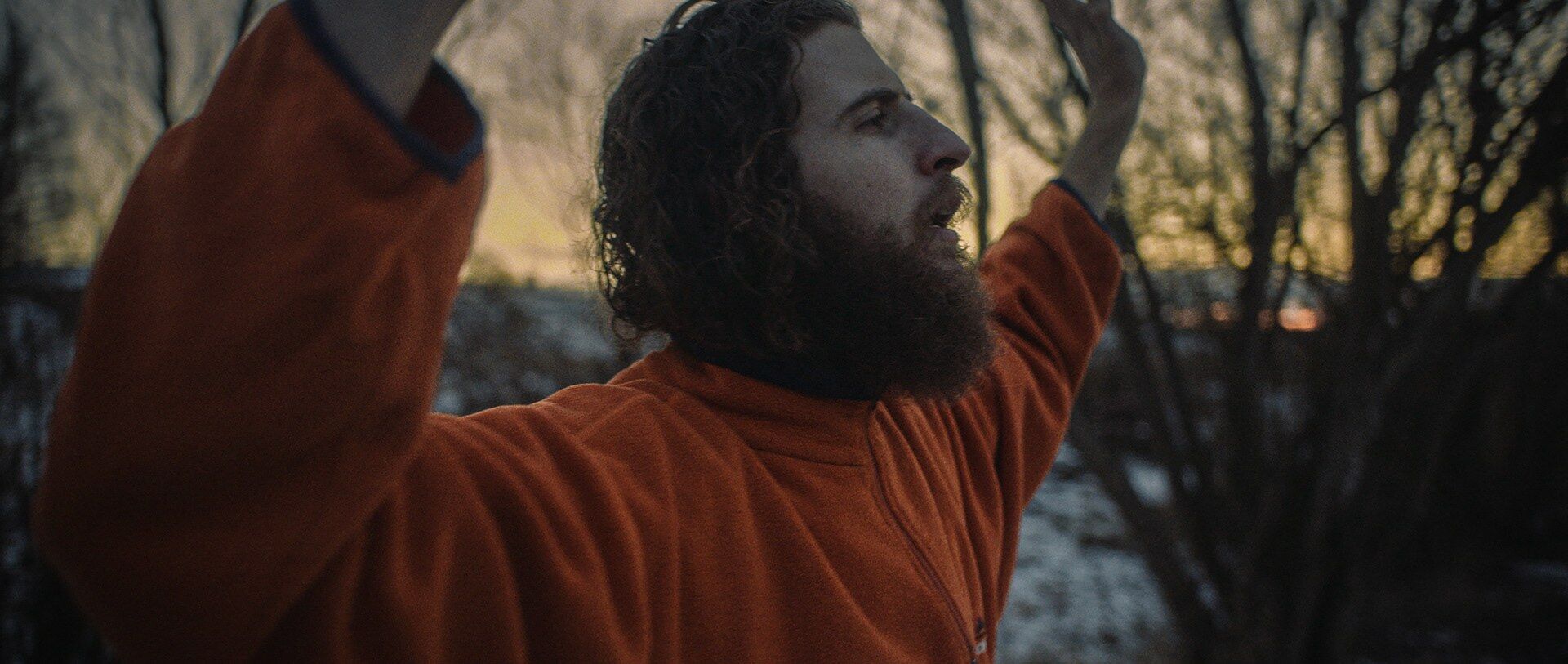An aspiring monk in an orange robe at dusk, 70% Selfless short documentary by Joris Skudra
