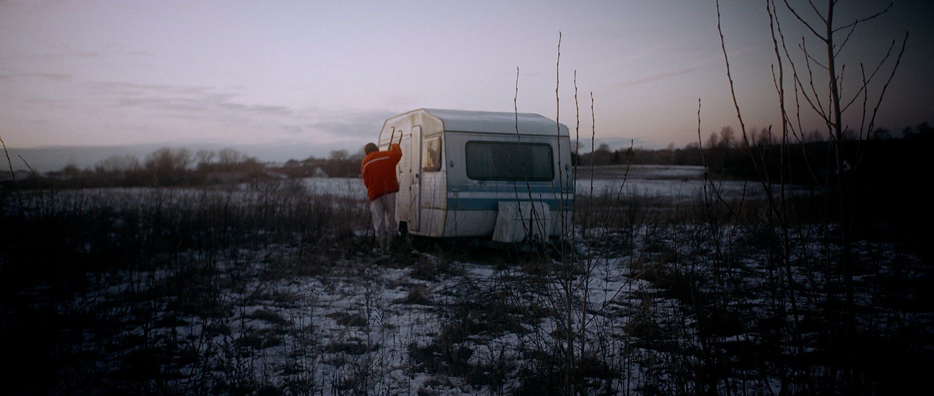 A caravan in a field at dusk, 70% Selfless
