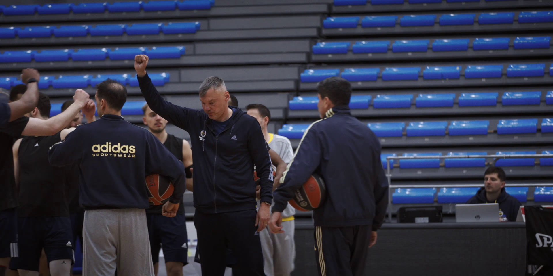 Fenerbahçe team huddle at practice in an empty arena, Chasing Glory documentary by Joris Skudra