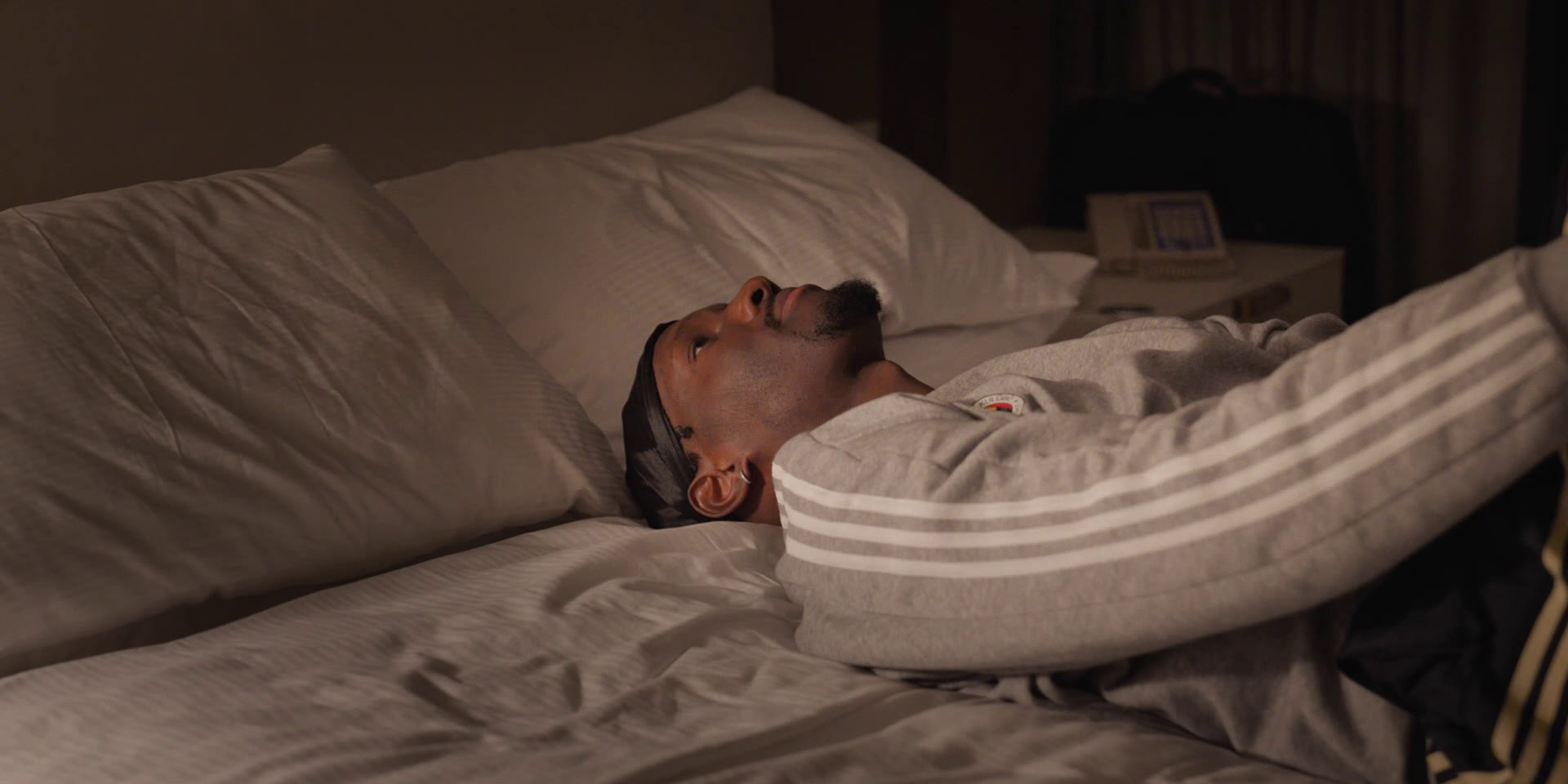 Nigel Hayes-Davis lying on a hotel bed before a game, Chasing Glory