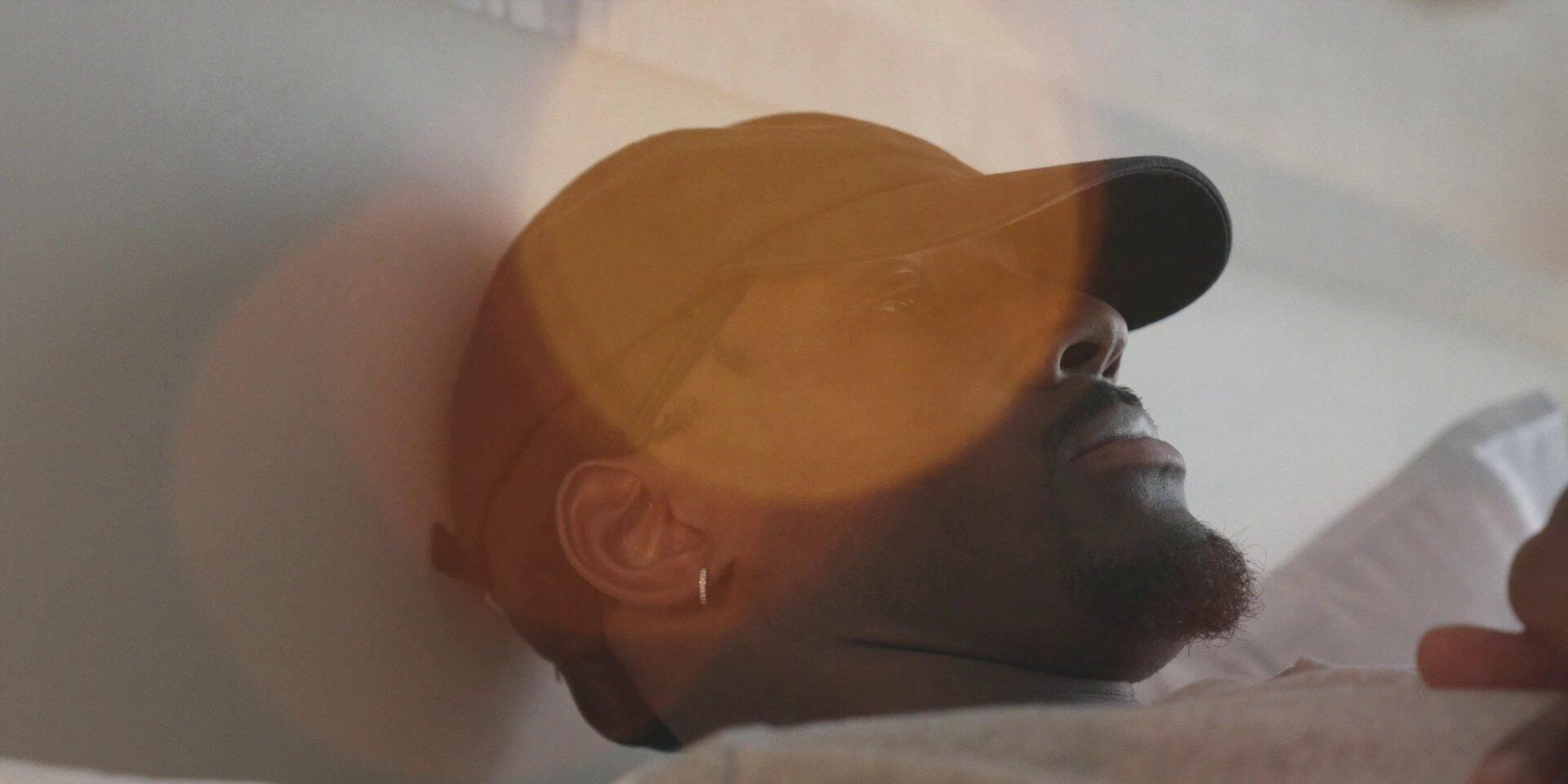 Nigel Hayes-Davis in a cap, close-up, Chasing Glory