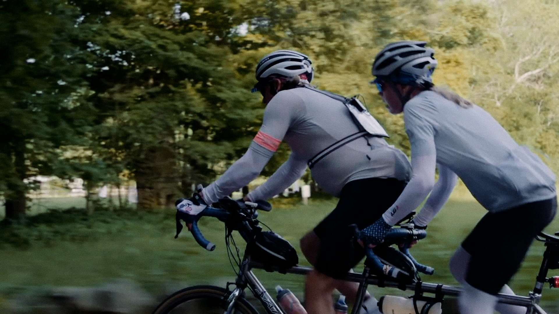 Ann and John Jurczynski riding their tandem bicycle through green countryside, Loving in Tandem for Great Big Story