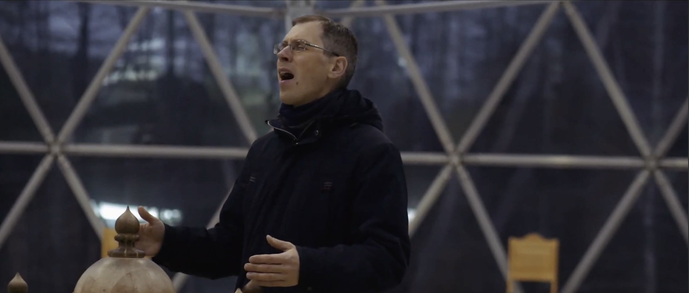 A man sings beneath the dome's steel frame, The Dome