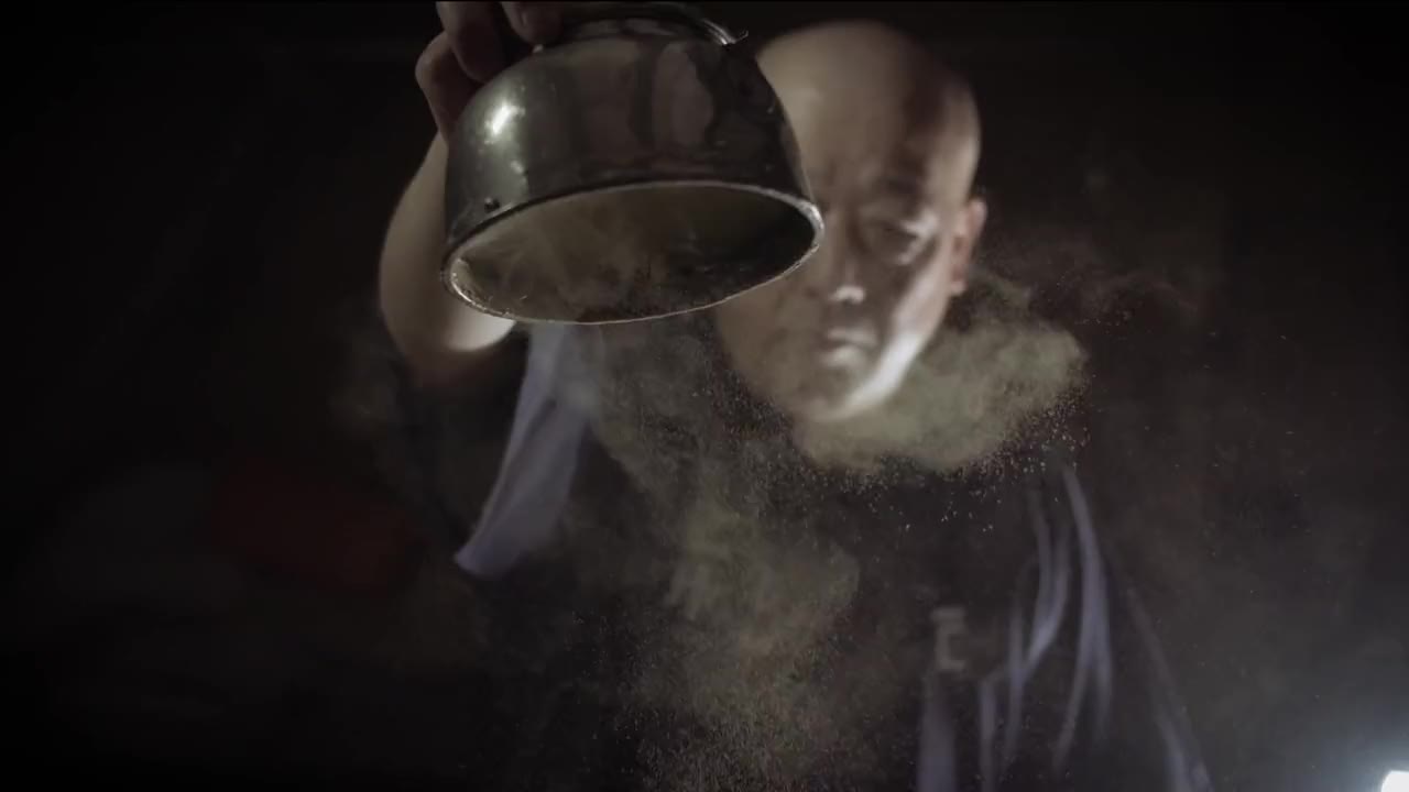 A Kanemasu brewer tipping a bowl of rice dust into the light, The Story of Takahashi