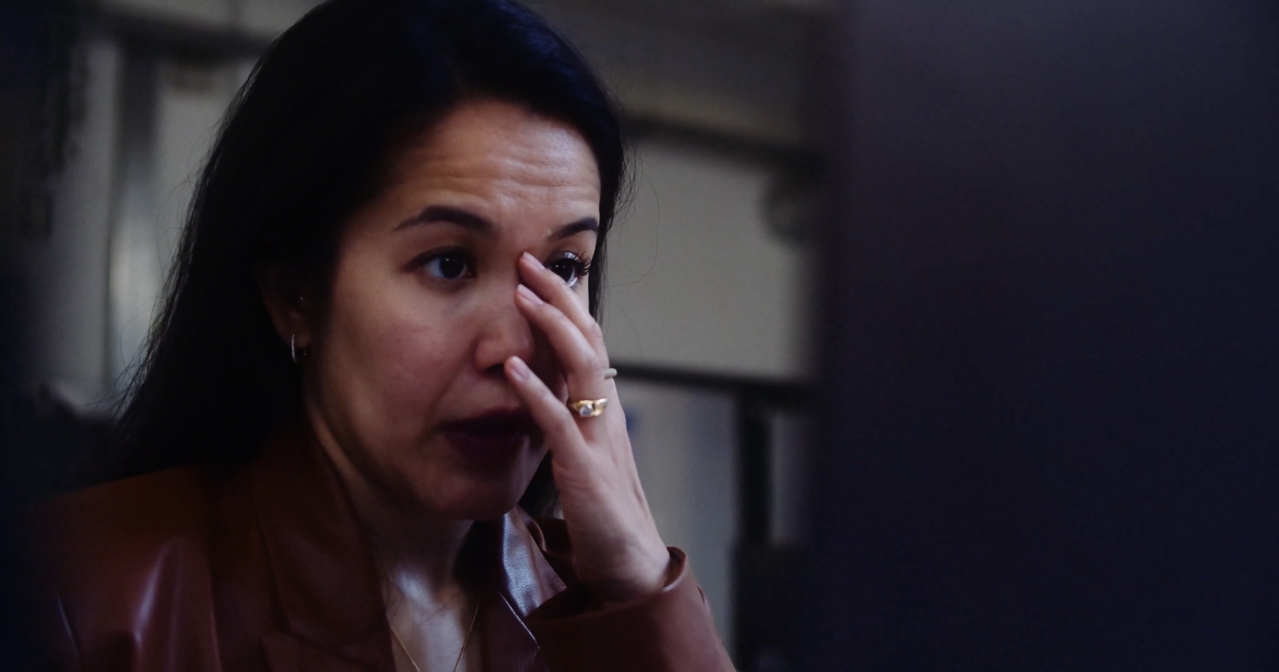 A woman in a quiet emotional moment at her desk, Women in Tech for CodeOp
